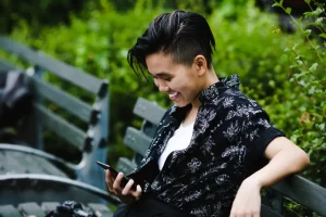 Person smiling outdoors enjoying a joyful moment away from work