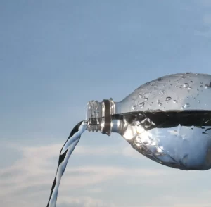 Water being poured into a glass illustrating healthy hydration habits