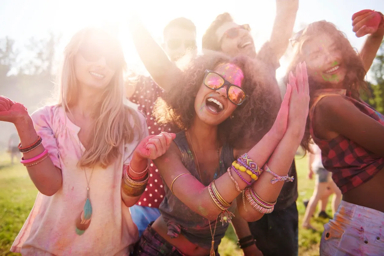Group of people laughing together illustrating the positive effects of humour on wellbeing