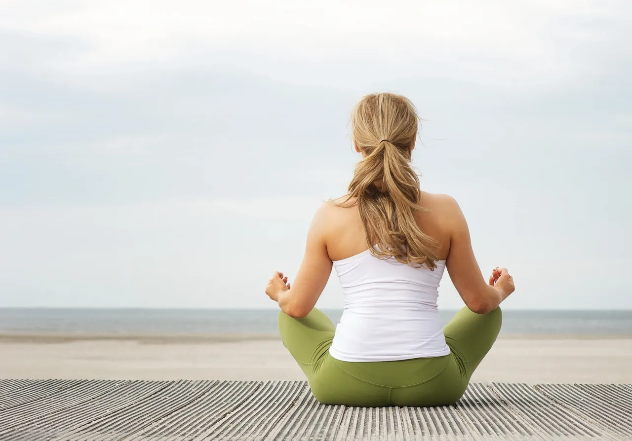 Person sitting calmly by the sea illustrating the importance of taking micro breaks