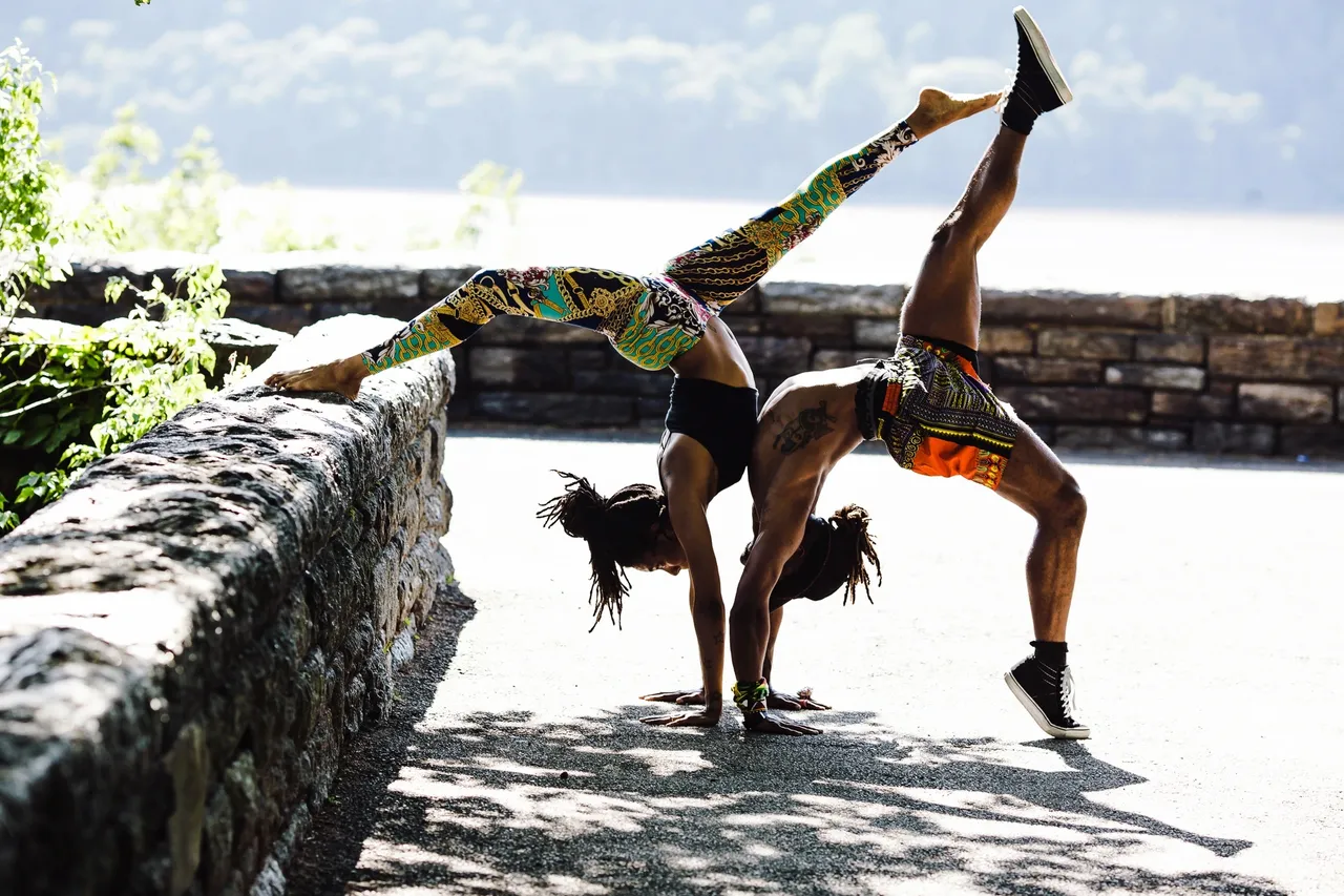People practicing mindful movement outdoors near water