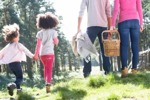 Family walking together outdoors surrounded by greenery and nature