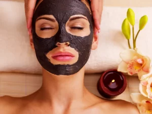 Person enjoying a relaxing self care moment with a facial mask
