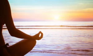 Person meditating at sunrise illustrating simple strategies for stress management